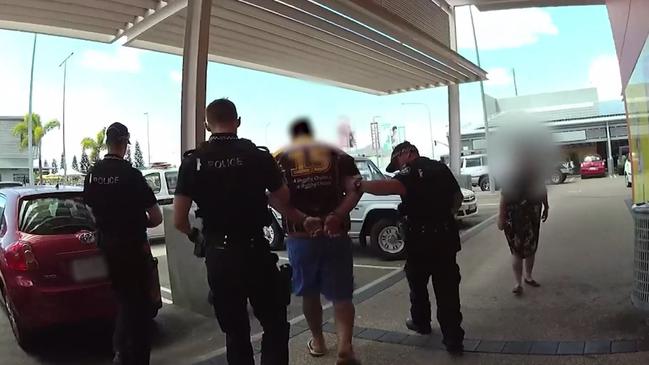 Police arrest a wanted man at Domain Central in Townsville.