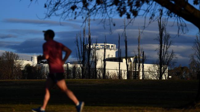 A jogger run past Questacon, Canberra’s National Science and Technology Centre.