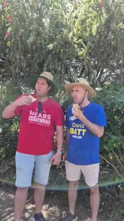 Usually at odds in politics, volunteers from the LNP and ALP, break party lines to share in a 'democracy sausage'