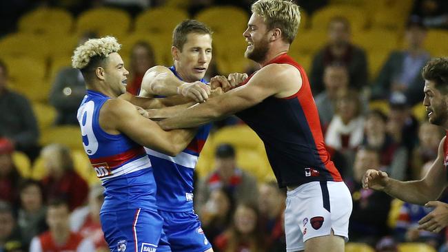 Jack Watts gets into Jason Johannisen. Picture: George Salpigtidis