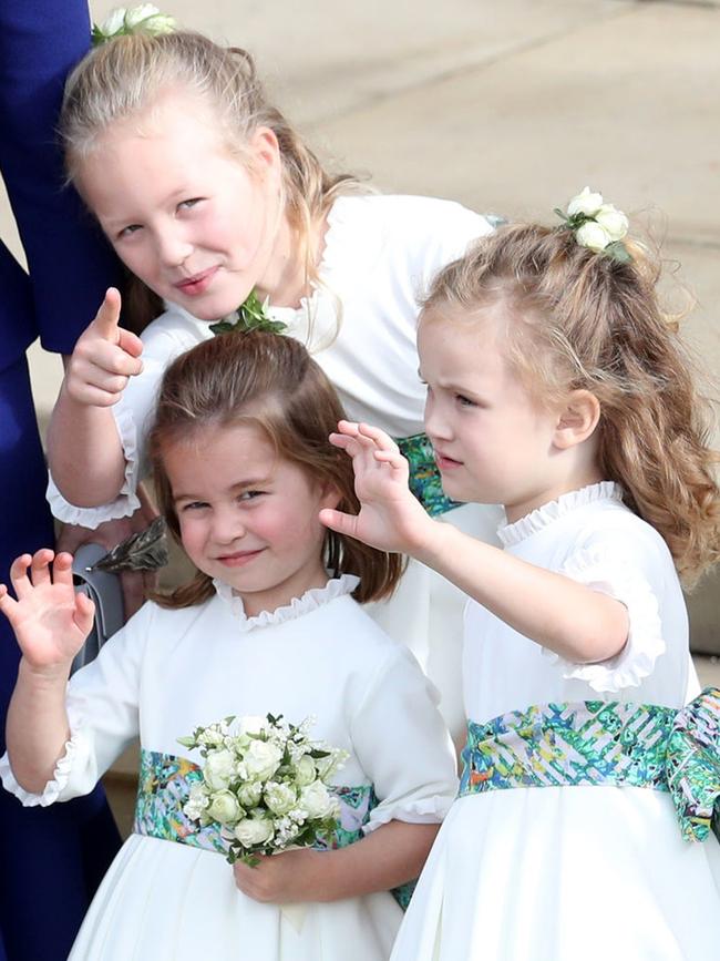 Bridesmaids Princess Charlotte of Cambridge, Savannah Phillips and Maud Windsor wave off Princess Eugenie and Jack Brooksbank. Picture: Getty