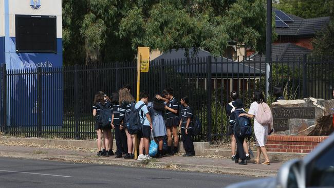 Marryatville High School School Students cross Kensington Road watched closely by teachers at the site where two students were injured after a truck allegedly ran a red light. Picture: Emma Brasier