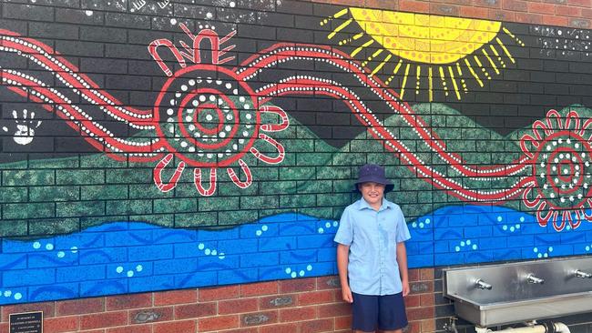 Braxton with a mural for his late brother, Elihjohn, at St Anthony's Catholic Primary School in Lara. Picture: Supplied