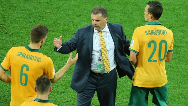 MELBOURNE, AUSTRALIA - JANUARY 09: Ange Postecoglou, coach of the Socceroos congratulates Matthew Spiranovic and Trent Sainsbury after the 2015 Asian Cup match between the Australian Socceroos and Kuwait at AAMI Park on January 9, 2015 in Melbourne, Australia. (Photo by Scott Barbour/Getty Images)