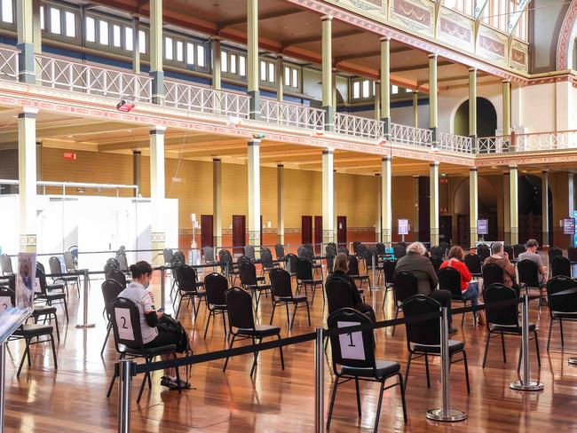 MELBOURNE, AUSTRALIA- NewsWire Photos 1 May 2021 : People wait for 15 minutes after receiving their AstraZeneca vaccine at the Royal Exhibition Building in Carlton. Picture : NCA NewsWire / Ian Currie