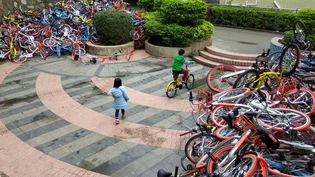 This picture taken on January 16, 2017 shows rented bicycles from bike-sharing firms near the entrance of Xiashan park in Shenzhen, Guangdong province. Picture: AFP/STR/China OUT