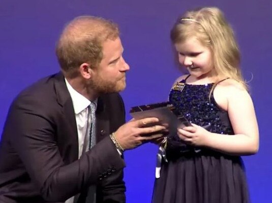 Prince Harry speaks with a little girl at the WellChild Awards in London. Picture: Supplied