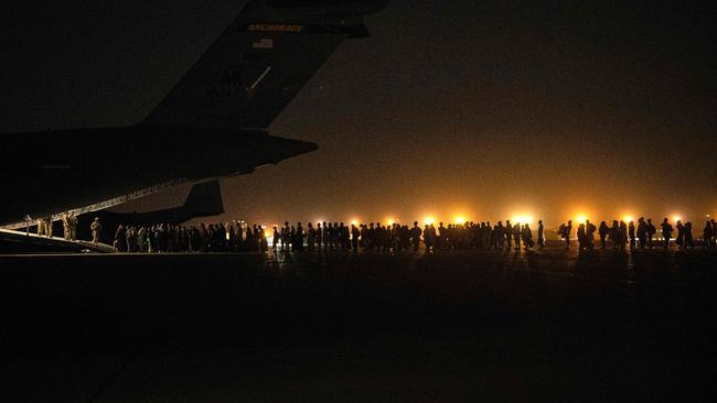 Afghans civilians are evacuated by the US military. Picture: Brandon Cribelar