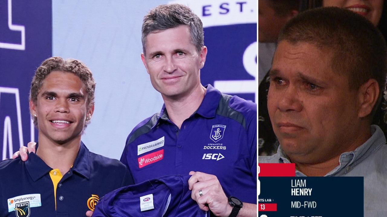 Justin Longmuir greets Liam Henry with his new Fremantle jumper, while his emotional father watches on.