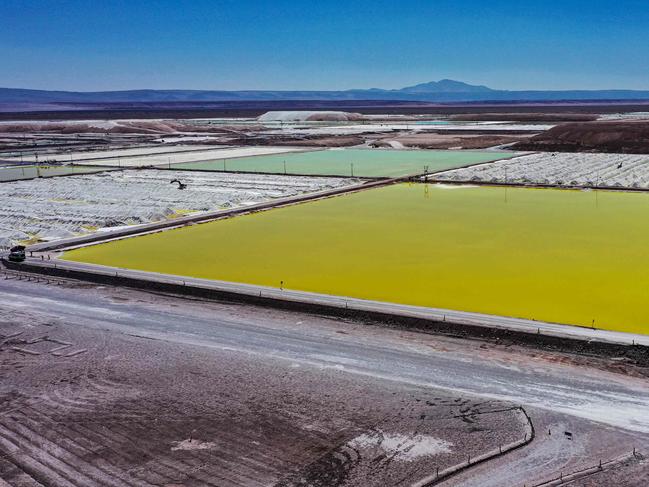 (FILES) Aerial view of brine ponds and processing areas of the lithium mine of the Chilean company SQM (Sociedad Quimica Minera) in the Atacama Desert, Calama, Chile, on September 12, 2022. Chile announced on April 15, 2024, that it expects to develop three to five new lithium projects over the next two years as part of a strategy to double its current production of the mineral. As the second-largest producer of lithium worldwideâa crucial component in electric vehicle battery productionâChile has formally initiated the process for private investors, both Chilean and foreign, to demonstrate their interest in developing lithium projects across 26 salt flats. These flats encompass 18% of the country's saline territory in South America. (Photo by Martin BERNETTI / AFP)