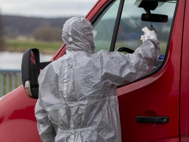 A medical worker measures the temperature of a passenger in the truck crossing German-Polish border at Slubice and Frankfurt. Picture: Maja Hitij/Getty