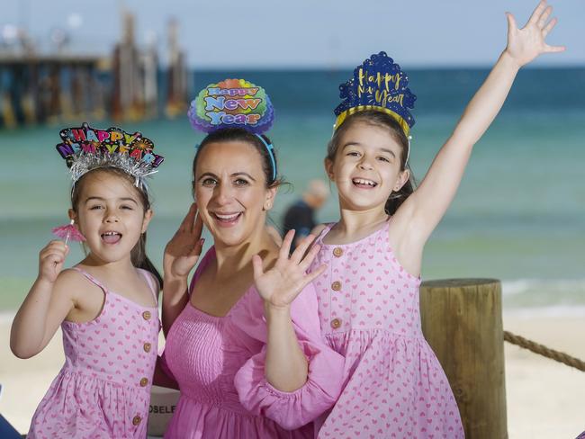 Wednesday DECEMBER 20 2023New Year Weather Pic at Glenelg. Georgianna 5, Sophia Zorbas (0426198390) Katerina 9 of Magill.Picture: Roy VanDerVegt