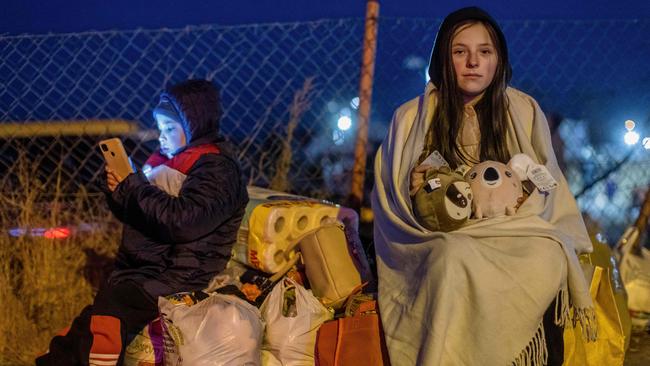 Helena, right, and her brother Bodia from Lviv at the Medyka pedestrian border crossing, in eastern Poland. Picture: AFP