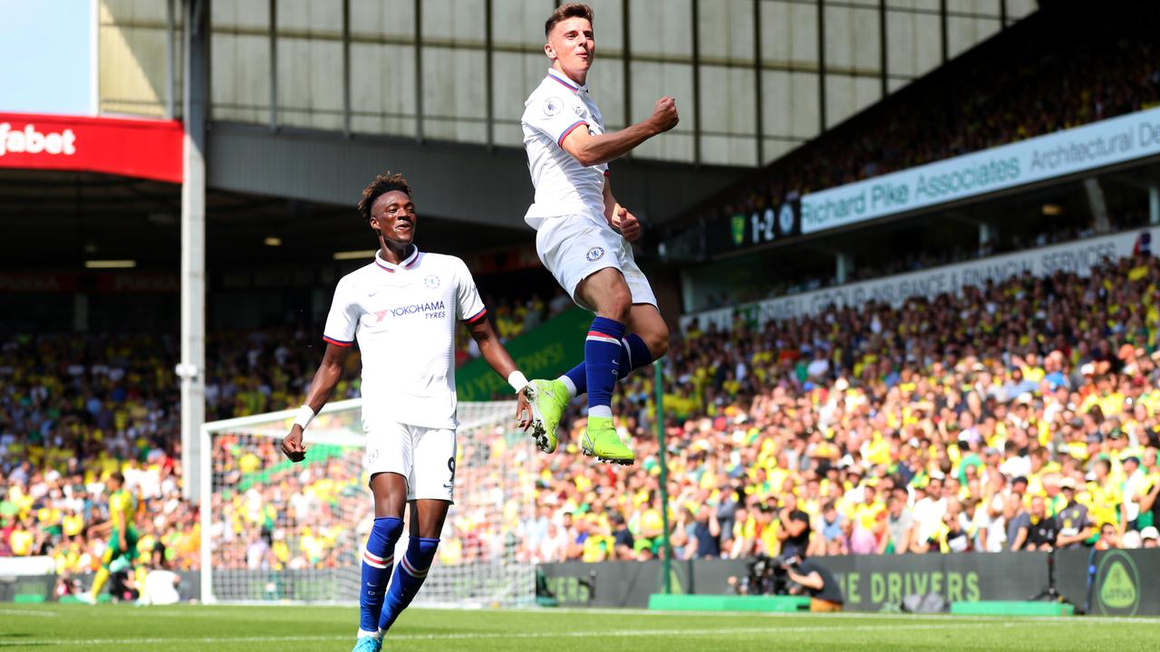 Mason Mount leaps in the air in front of Tammy Abraham after scoring.