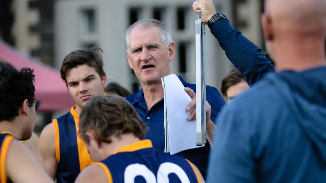 Mark Mickan talks to St Michael’s players at the quarter-time huddle on Saturday. Picture: AAP / Morgan Sette