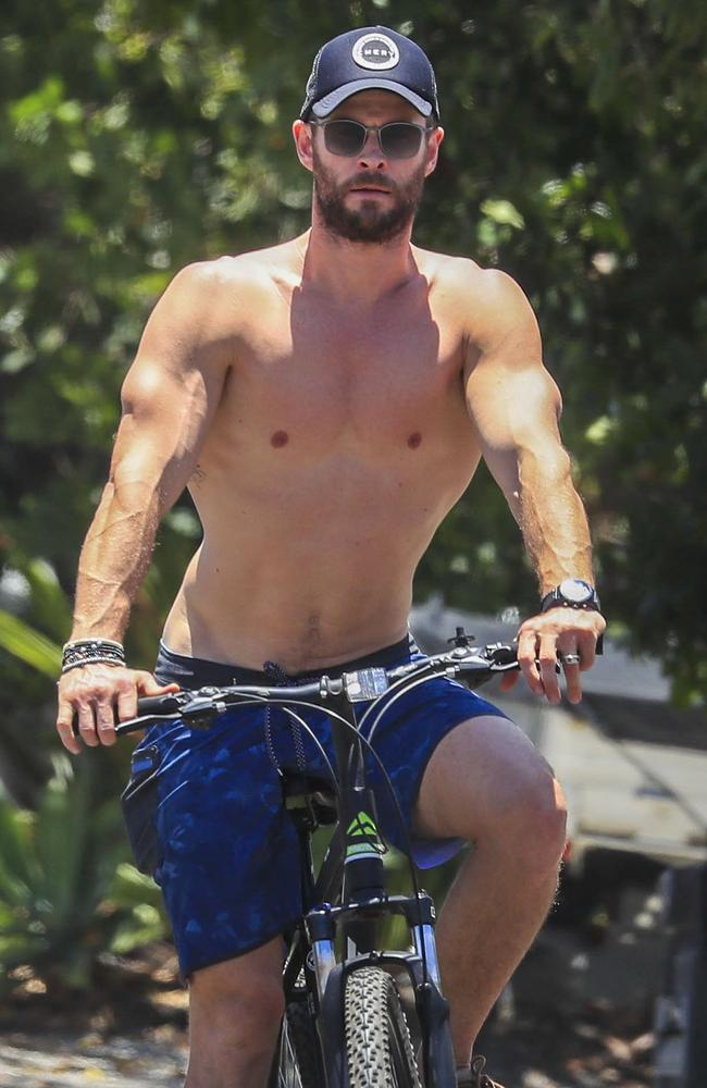 Chris Hemsworth showed off his incredibly toned body as he rode a mountain bike with his family in Byron Bay. Picture: Media Mode