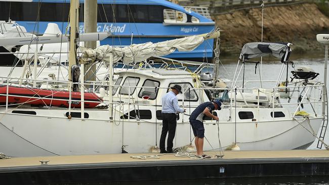 Townsville residents attend to their boats at the Ross Creek Marina ahead of Cyclone Kirrily making landfall. Picture: Ian Hitchcock