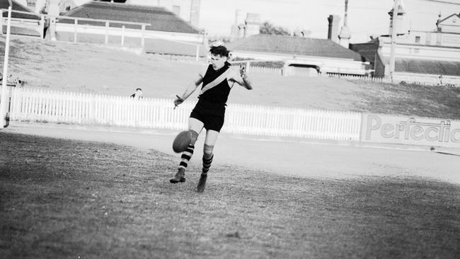 Jack Dyer kicking a football at Punt Road Oval. 