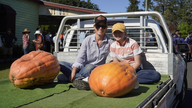 Lovisa and Bella Heeb with Bella's winning 25kg pumpkin she started growing in Janruary at the Goomeri Pumpkin Festival 2024
