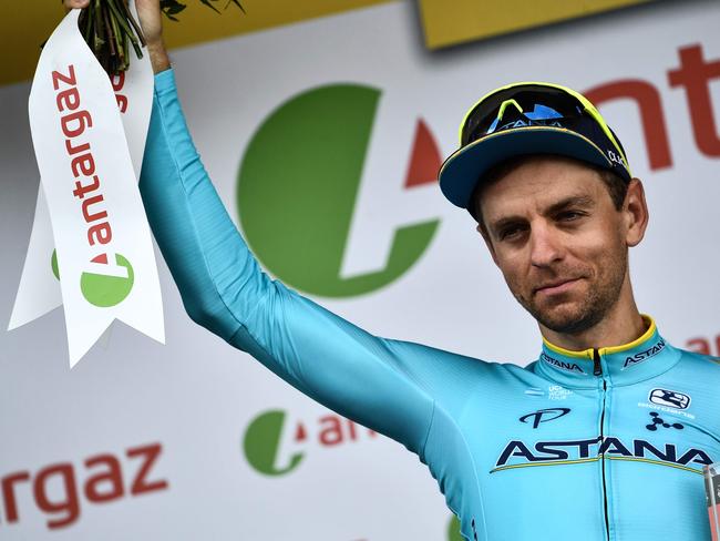 Estonia's Tanel Kangert celebrates on the podium after he received a prize for being the stage's most aggressive rider