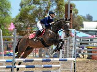 EQUINE LEAP: Darcey Tait is competing in the Queensland Interschool State Showjumping Championship. Picture: Contributed