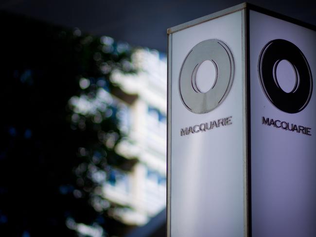 The Macquarie Group Ltd. logo is displayed on a signpost at the Macquarie Group Building in Sydney, Australia, on Friday, April 27, 2012. Macquarie Group Ltd., Australia's largest investment bank, said it's relying on cost cuts to revive earnings after a slump in trading income and dealmaking dragged full-year net income to an eight-year low. Photographer: Ian Waldie/Bloomberg