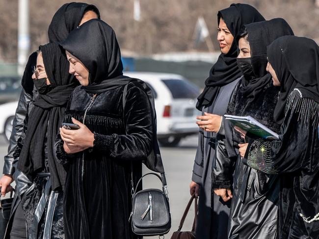 Afghan female students studying health studies walk along a street in Kabul on December 3, 2024. (Photo by Wakil KOHSAR / AFP)