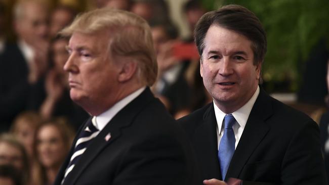 US President Donald Trump (left) attends the swearing in of Brett Kavanaugh (right) as Associate Justice of the US Supreme Court at the White House in October last year. Picture: AFP