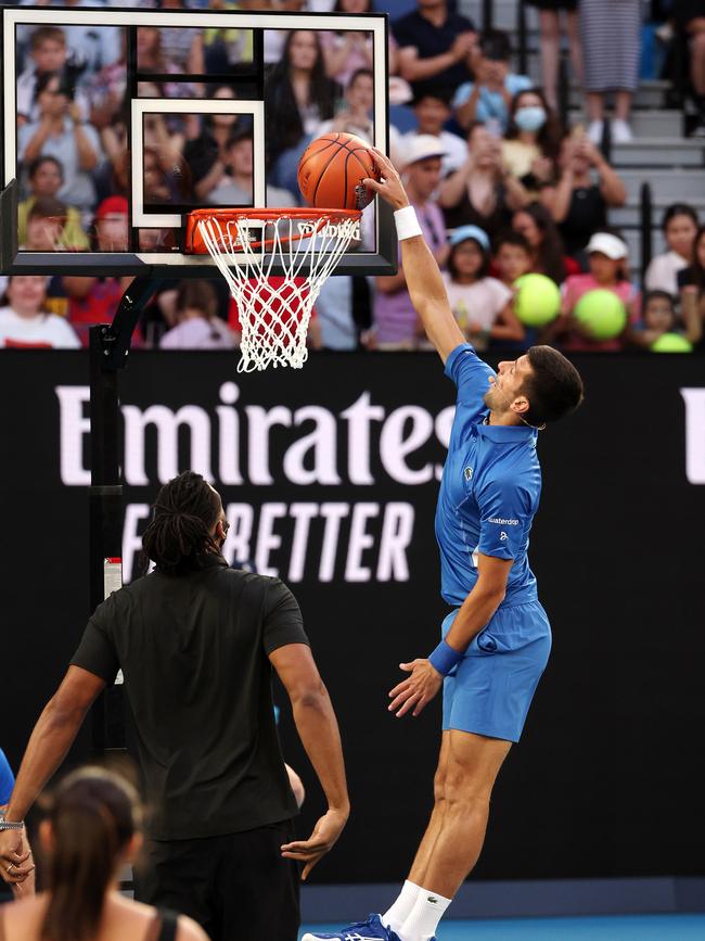 Djokovic shooting hoops with NBL star and former NBA player Alan Williams on Rod Laver Arena. Picture: Mark Stewart