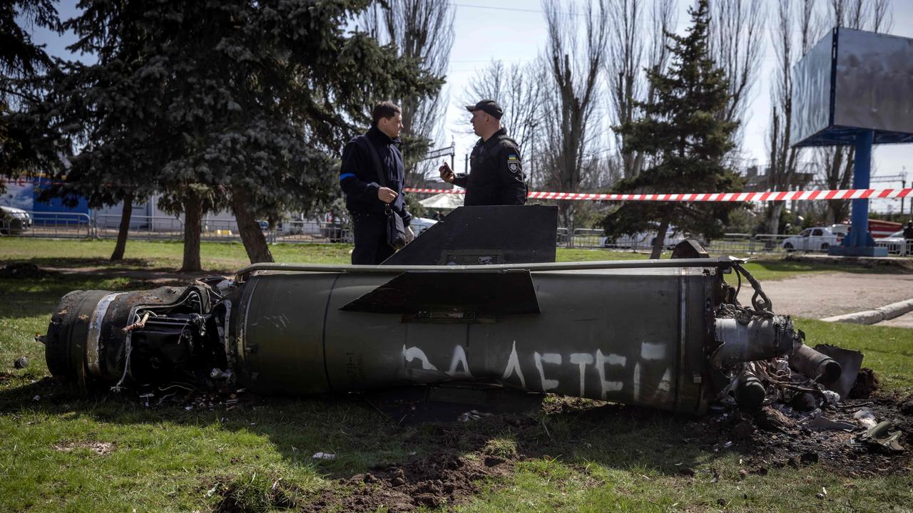 Ukrainian police inspect the remains of a large rocket with the words ‘for our children’ written in Russian. Picture: Fadel Senna/AFP