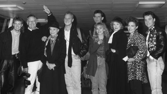 The heady days of Neighbours-mania when Craig McLachlan, Ian Smith, Anne Haddy, Alan Dale, Paul Keane, Annie Jones, Anne Charleston, Fiona Corke and Stefan Dennis had just landed in London ahead of their appearance at the Royal Variety Performance in London 1988. Picture: Express Newspapers/Getty Images