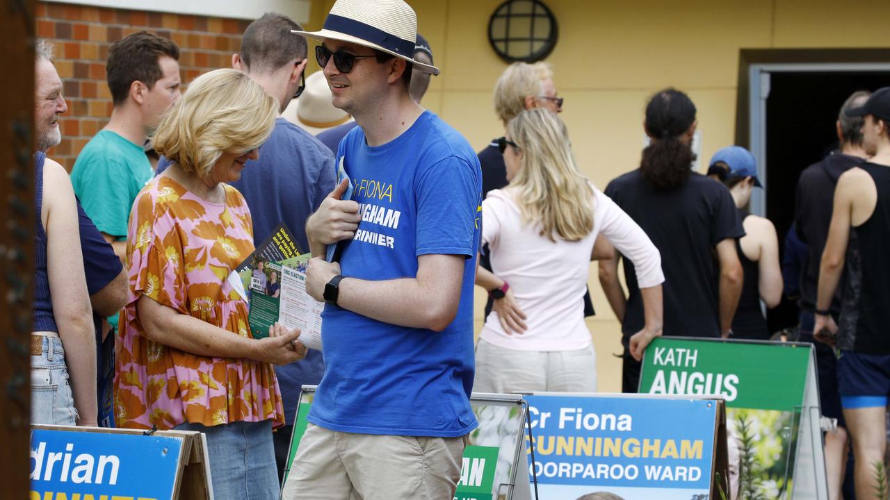 Voters and party members line up at the Coorparoo State School during the Saturday’s local government elections. Picture: NCA NewsWire/Tertius Pickard