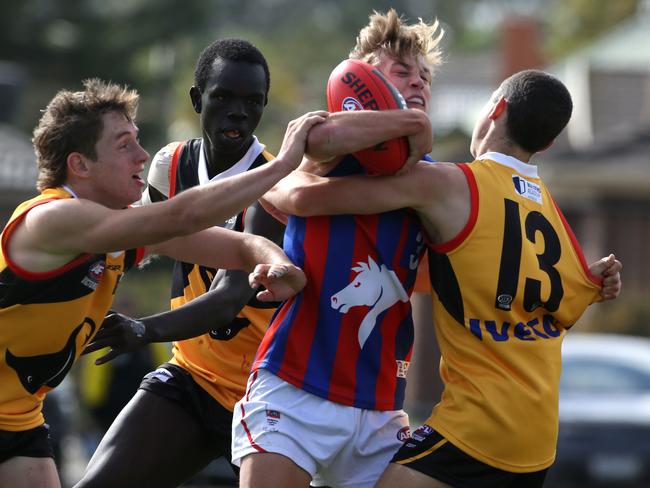 Joseph Ayton- Delaney is taken in a tackle by a fever of Stingrays. Picture: Stuart Milligan