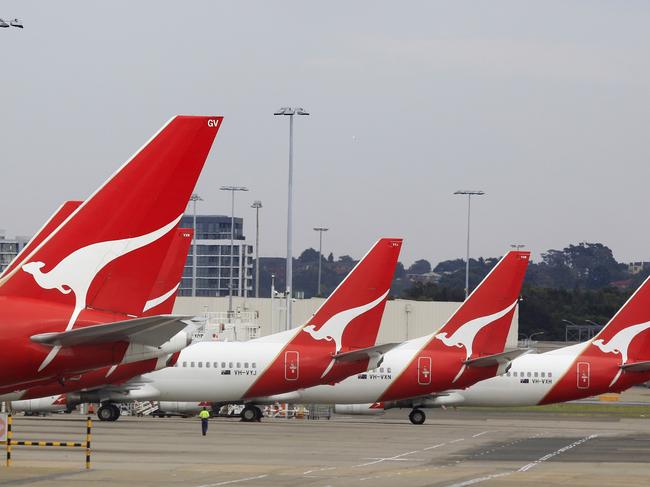 The tails of Qantas planes are lined up at Sydney Airport in Sydney, Sunday, Oct. 30, 2011. Qantas Airways grounded all of its aircraft around the world indefinitely Saturday due to ongoing strikes by its workers. (AP Photo/Rick Rycroft)