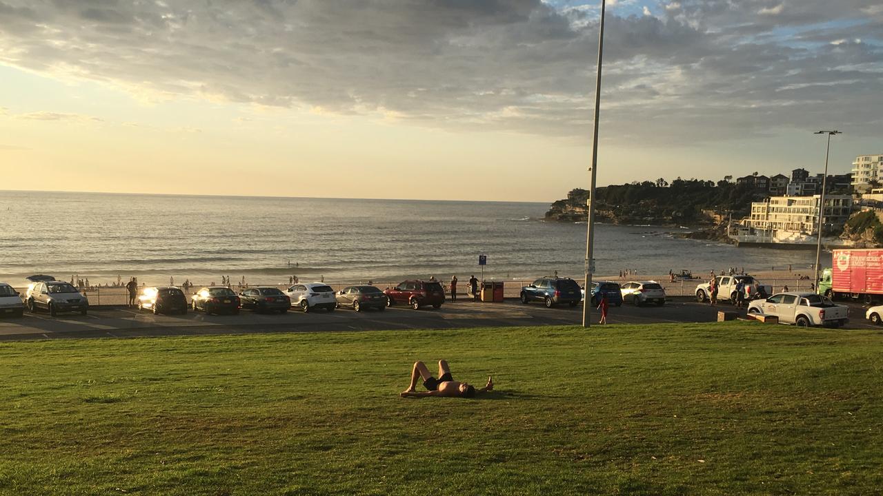 One man lies in Bondi after celebrating. Picture: Henry Lynch