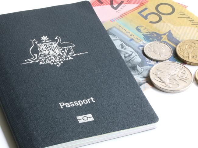 Australian passport with some money on white background.