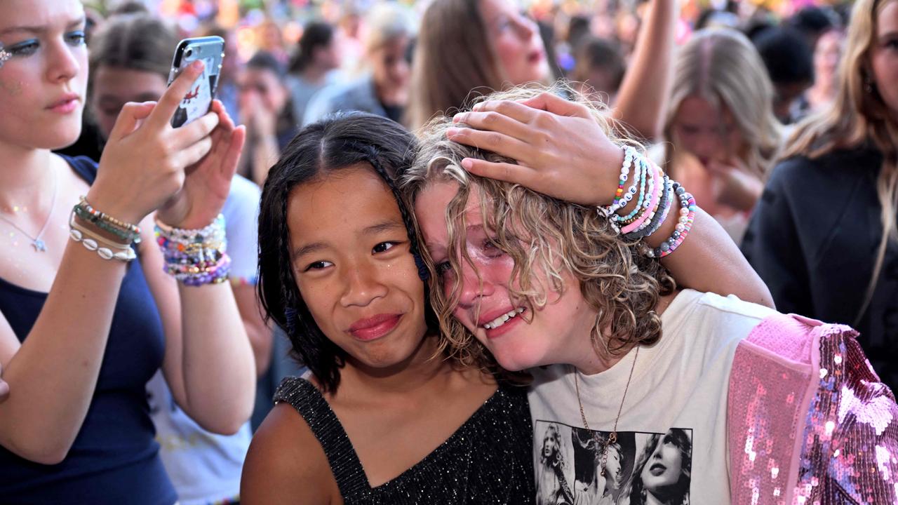 Ticketless fans for US singer Taylor Swift, also known as a Swifties, stand outside at the MCG. (Photo by William WEST / AFP)