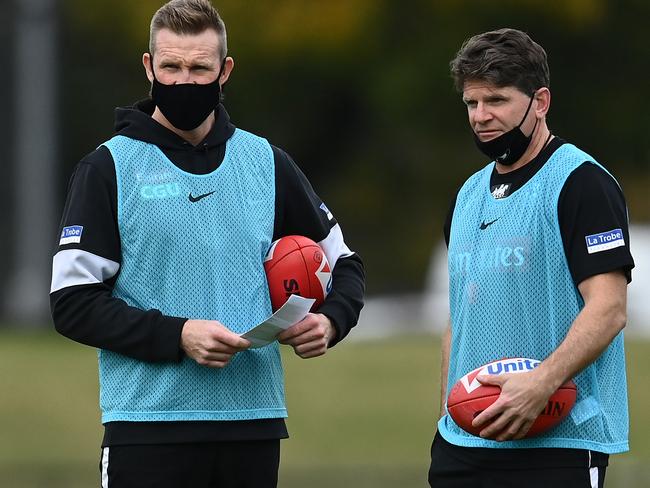 MELBOURNE, AUSTRALIA - JUNE 01: Magpies head coach Nathan Buckley talks to assistant coach Robert Harvey during a Collingwood Magpies AFL training session at Holden Centre on June 01, 2021 in Melbourne, Australia. (Photo by Quinn Rooney/Getty Images)