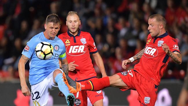 ADELAIDE, AUSTRALIA - MARCH 16: Michael Jakobsen of Melbourne City competes for the ball with Daniel Adlung of United during the round 23 A-League match between Adelaide United and Melbourne City at Coopers Stadium on March 16, 2018 in Adelaide, Australia.  (Photo by Daniel Kalisz/Getty Images)