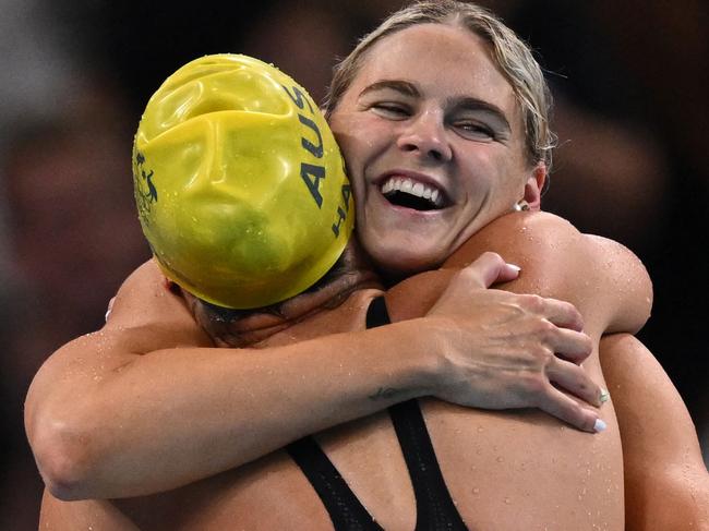 Australia's Shayna Jack (R) and Australia's Meg Harris celebrates after winning the final of the women's 4x100m freestyle relay swimming event at the Paris 2024 Olympic Games at the Paris La Defense Arena in Nanterre, west of Paris, on July 27, 2024. (Photo by SEBASTIEN BOZON / AFP)