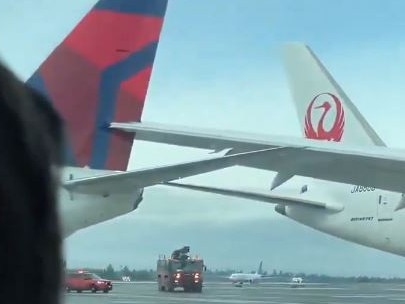 An onlooker captures the moment the Japan Airlines plane struck a parked Delta Airlines plane in Seattle. Picture: Supplied