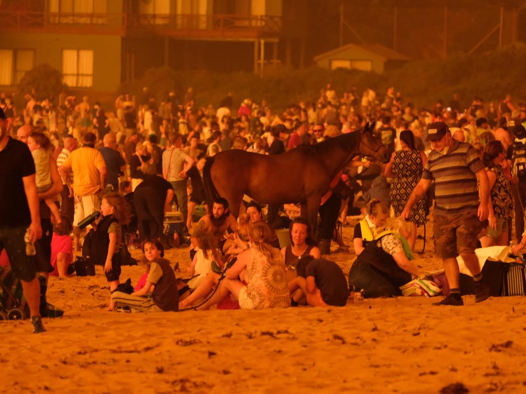 Bushfire arrives into the township of Malua Bay NSW, just south of Batemans Bay. Locals seek refuge on the beach as the fire approaches. Picture: Alex Coppel.