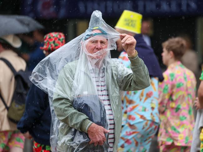 MELBOURNE, AUSTRALIA- NewsWire Photos DECEMBER 26 2023Crowds try to escape the rain as the leave day one of this yearÃs Boxing Day Test which is set to be a battle of wills as current world test champions Australia take on Pakistan in the second of a three-test series at the iconic Melbourne Cricket Ground.The Boxing Day Test is a Victorian institution and has been a highlight of the summer of cricket every year since 1980 with thousands of cricket fans on the edge of their seat at the MCG.Picture: NCA NewsWire /Brendan Beckett