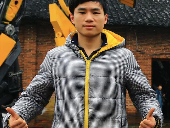 Yu Lingyun, left, and his father Yu Zhilin, both farmers, pose with Transformers models made from used car parts in front of a factory in Zhangmu town, Hengyang county, central Chinas Hunan province, 14 March 2015. In yet another example of the limitless ingenuity of Chinese farmers, a Hunan farmer and his son have made a thriving business, raking in more than a million yuan in revenue each year by making and selling realistic model Transformers. When the Transformers films began to explode in popularity in China (the latest installment is the highest grossing film in China of all time), farmer Yu Zhilin of Zhangmu township in Hengyang county saw a promising business opportunity. With a background in the fine arts to work from, an abandoned factory to work in, used car parts and images downloaded from the internet to work with and a son to help out, he began to make some pretty incredible Transformers models. It was understandably difficult at first, according to Sina News. The first model took him three years to complete, but with experience and his son's help, he has now turned himself into the unquestioned top amateur Transformers-builder. The father and son's work attracts a constant stream of visitors and brings in a tidy profit of more than one million RMB each year. They are reportedly really excited about the next Transformers flick.