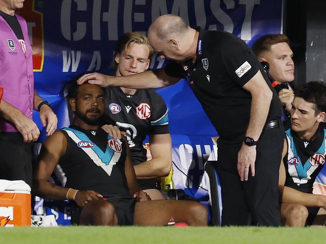 NCA. MELBOURNE, AUSTRALIA. 13th April, 2025 . Gather Round.  Port Adelaide vs Hawthorn at the Adelaide Oval.  Ken Hinkley, head coach of the Power talks with Willie Rioli on the bench late in the match   . Picture: Michael Klein