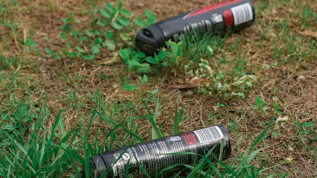 Aerosol cans discarded in a park. Picture Glenn Campbell