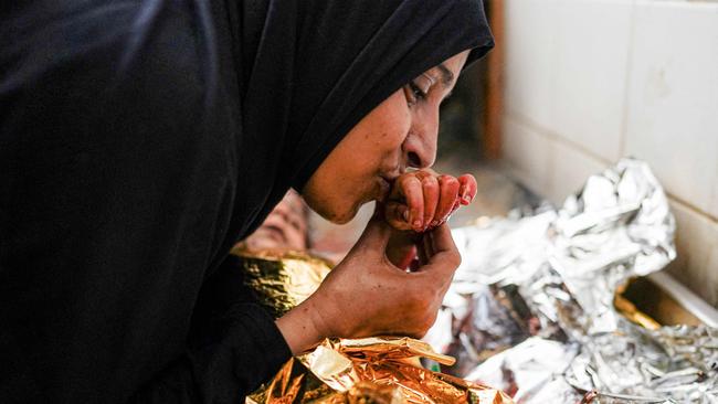 A mother bids farewell to her child who was killed in the aftermath of overnight Israeli bombardment. Picture: AFP