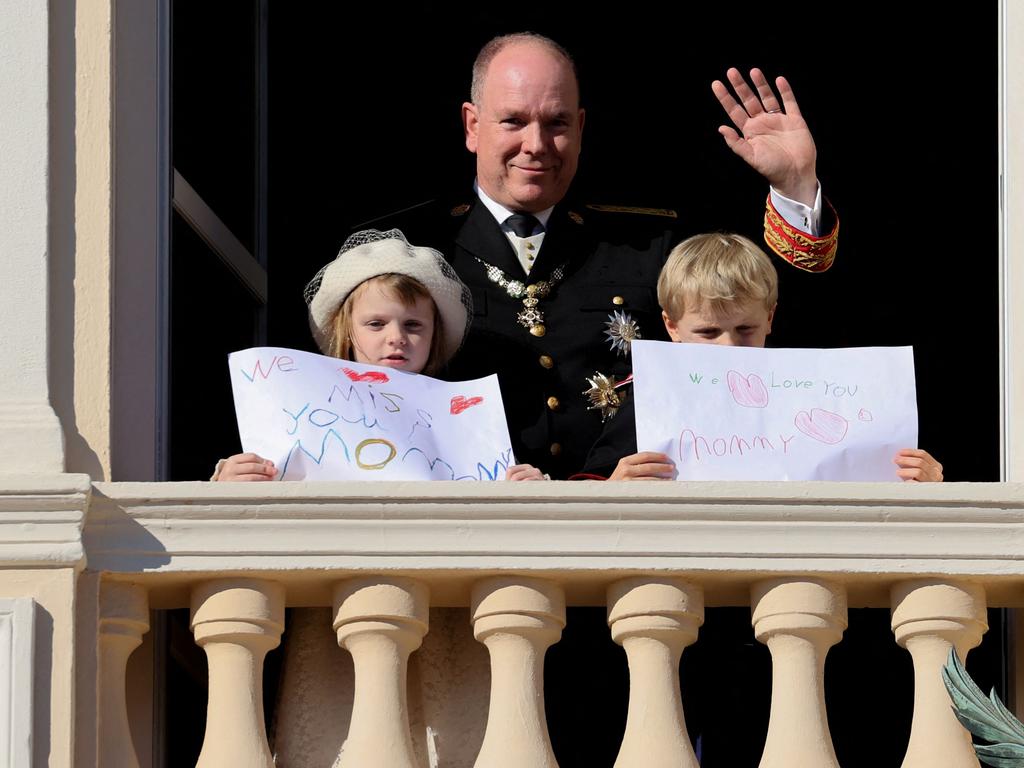 Princess Gabriella and Prince Jacques stand with a message for Princess Charlene at the balcony of Monaco Palace. Picture: Valery Hache/AFP