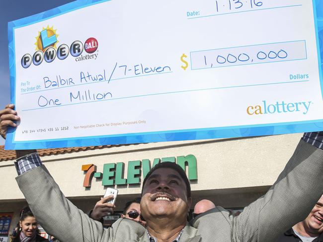 CHINO HILLS, CA - JANUARY 14: Balbir Atwal, owner of the California 7-Eleven that sold one of the 3 Powerball winning tickets, holds up a $1 million check after received from the California State Lottery, in front of his store on January 14, 2015 in Chino Hills, California. Winning tickets were also sold in Florida and Tennessee and will share an estimated record-breaking $1.58 billion dollar jackpot. Ringo Chiu/Getty Images/AFP == FOR NEWSPAPERS, INTERNET, TELCOS & TELEVISION USE ONLY ==