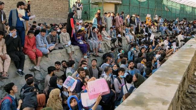 Crowds of people wait outside the airport in Kabul. Picture: Twitter/David_Martinon via Reuters